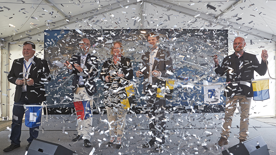 Confetti rain over five people who inaugurate Port of Kapellskär