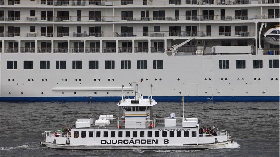 Small archipelago vessel passes large cruise vessel