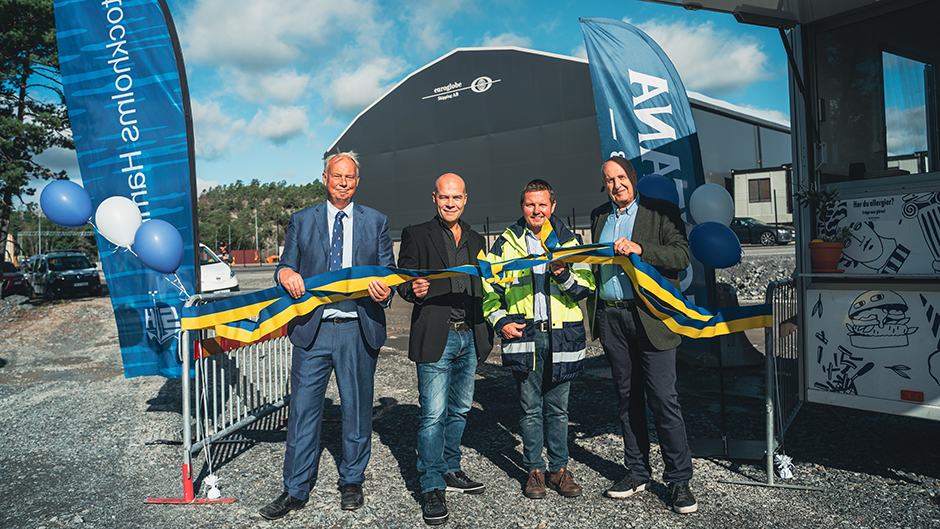 Four men tying a symbolic blue and yellow knot