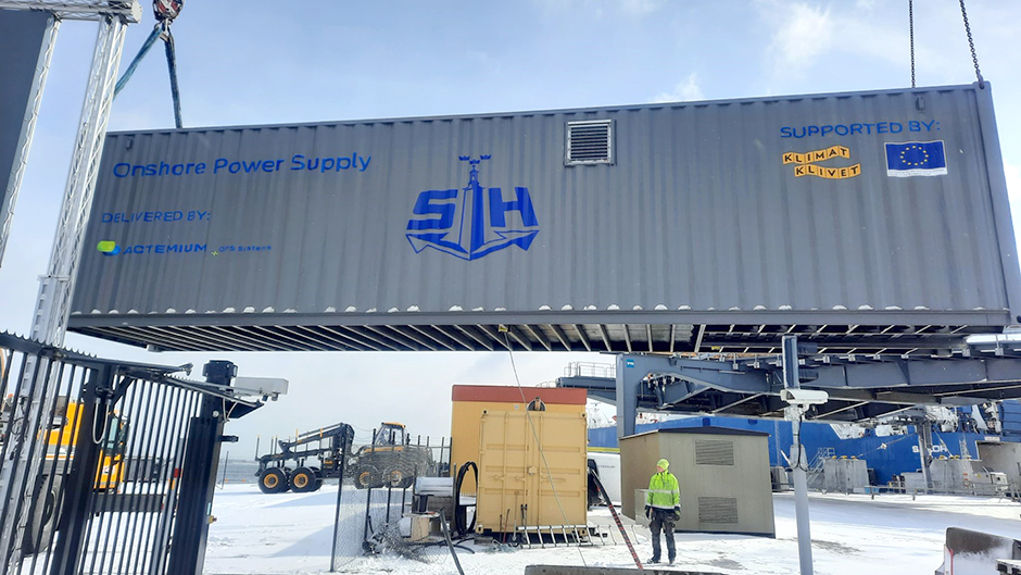 Container containing  onshore power supply is lifted off ground