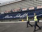 Two deputy harbour masters wearing facemasks in front of Mein Schiff 1