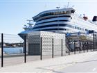 Onshore power connection building in front of a cruise ship