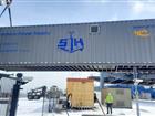 Container containing  onshore power supply is lifted off ground